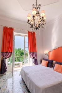 a bedroom with a large bed and a large window at Hotel Villa Maria in Ravello