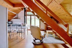 a staircase in a living room with a table and chairs at LA FARIO 2 in Gavarnie