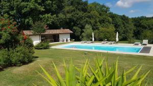a swimming pool in a yard next to a house at Maison d hotes Lapitxuri in Arcangues