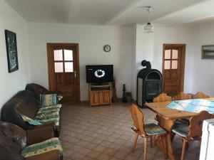 ein Wohnzimmer mit einem Tisch und einem TV in der Unterkunft Samota jak víno in Jihlava