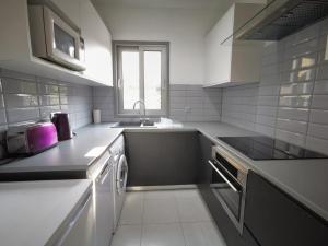 uma cozinha com um lavatório e uma máquina de lavar louça em King Alexander Villa 22 em Pafos