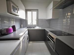 a kitchen with a sink and a dishwasher at King Alexander Villa 22 in Paphos City