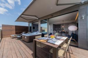 a kitchen and dining room with a tub on a deck at La Marine in Melenara