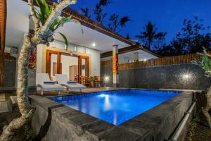 a swimming pool in the backyard of a house at Ambengan Private Villas in Nusa Penida