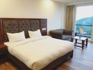 Letto o letti in una camera di Hotel Chail Residency
