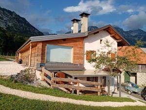 a log cabin with a large window on the side of it at Casera Pian Grand Wellness Lodge in Chies dʼAlpago