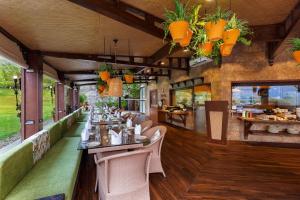 a restaurant with a long table and chairs at Aloha On The Ganges by Leisure Hotels in Rishīkesh