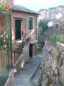 a small house with a porch and a stone wall at Ca' di Ro in Camogli