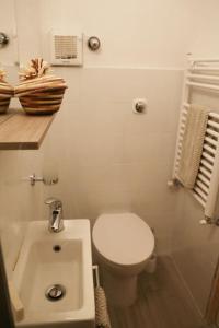 a bathroom with a white toilet and a sink at Ca' di Ro in Camogli