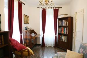 a living room with red curtains and a chandelier at Ca' di Ro in Camogli