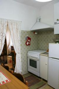a kitchen with a white oven and a table with a table at Ca' di Ro in Camogli