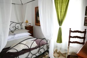 a bedroom with a bed with white curtains at Ca' di Ro in Camogli