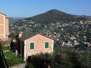 a pink house in front of a mountain at Ca' di Ro in Camogli