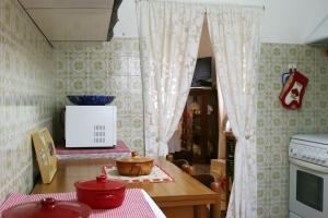 a kitchen with a table and a counter with a microwave at Ca' di Ro in Camogli