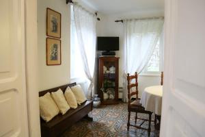 a living room with a couch and a tv and window at Ca' di Ro in Camogli