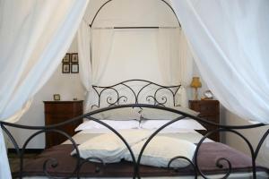 a bedroom with a canopy bed with white curtains at Ca' di Ro in Camogli