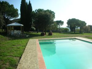 a swimming pool in a yard with a gazebo at Casa Vacanze Podere Casacce in San Casciano in Val di Pesa