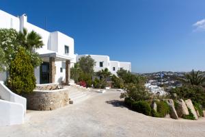 a white house with a view of a city at Tharroe of Mykonos Boutique Hotel in Mikonos