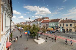 a group of people walking on a city street at Mid City Apartments in Cluj-Napoca