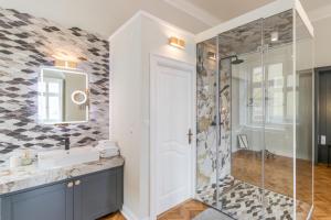 a bathroom with a shower and a sink at Mid City Apartments in Cluj-Napoca +99 photos