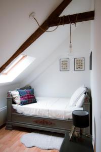 a bedroom with a bed in a attic at La Ville Tanet in Landéhen