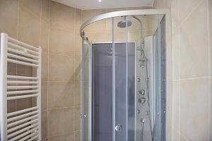 a shower with a glass door in a bathroom at La Ville Tanet in Landéhen +15 photos