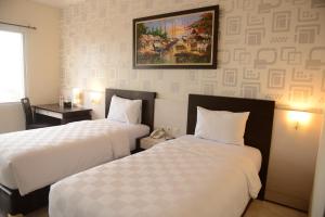 Postelja oz. postelje v sobi nastanitve Hotel 88 Jember By WH - Strategic Location In The City Center