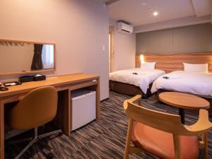 Tempat tidur dalam kamar di Central Hotel Takeoonsen Ekimae