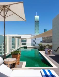 a swimming pool on the roof of a building at The Merchant House in Manama