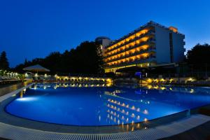 a hotel with a large swimming pool at night at Sofia Hotel - All Inclusive & Private Beach in Golden Sands