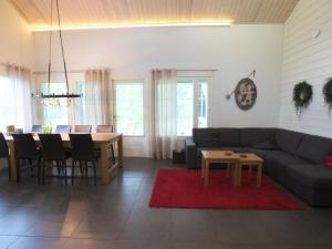 a living room with a couch and a table at Holiday Home Ylläskumpu 1 in Ylläsjärvi