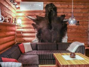 a living room with a bear head on the wall at Holiday Home Revonkanta by Interhome in Kauhaniemi