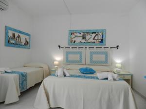 Postel nebo postele na pokoji v ubytování Hotel Canne al Vento
