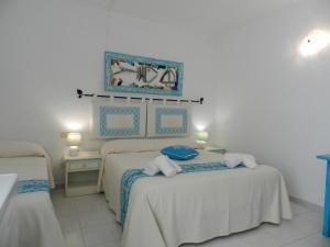 Postel nebo postele na pokoji v ubytování Hotel Canne al Vento