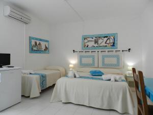 Postel nebo postele na pokoji v ubytování Hotel Canne al Vento