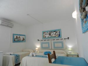 Postel nebo postele na pokoji v ubytování Hotel Canne al Vento