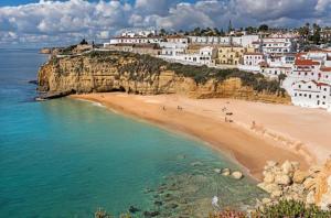 a view of a beach with buildings on a cliff at Carvoeiro Bay Apartment in Carvoeiro
