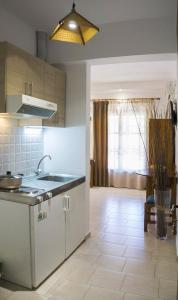 a kitchen with a sink and a counter top at Tanias House in Platanias