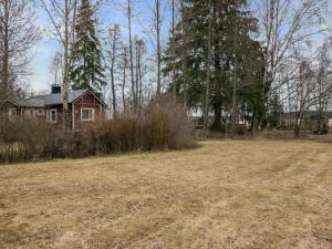 an empty field in front of a house at Holiday Home C by Interhome in Porvoo