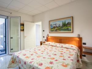 A bed or beds in a room at Villa La Rosa by Interhome
