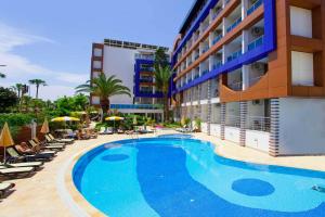 a large swimming pool in front of a hotel at Gardenia Hotel in Alanya