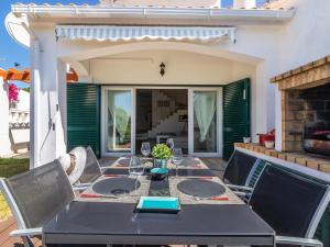 a dining table and chairs on a patio at Holiday Home Roberts by Interhome in Albufeira