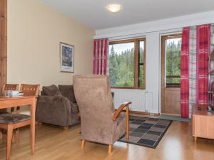 a living room with a couch and a table at Holiday Home Ylläs chalets a507 by Interhome in Ylläsjärvi