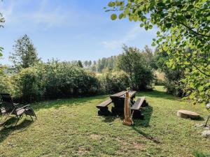 a picnic table in the grass in a field at Holiday Home C by Interhome in Porvoo