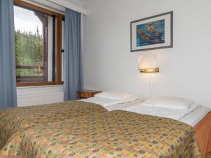 a hotel room with a bed and a window at Holiday Home Ylläs chalets a507 by Interhome in Ylläsjärvi +12 photos
