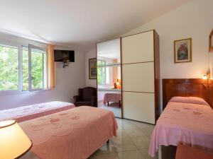 A bed or beds in a room at Villa La Rosa by Interhome