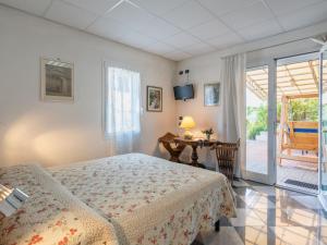 A bed or beds in a room at Villa La Rosa by Interhome