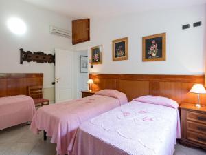 A bed or beds in a room at Villa La Rosa by Interhome
