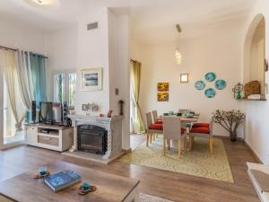 a living room with a table and a living room with a tv at Holiday Home Roberts by Interhome in Albufeira