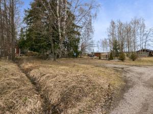 an empty field with hay on the side of a road at Holiday Home C by Interhome in Porvoo